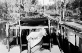 Boat near shad fishing nets at dock - Palatka, Florida.