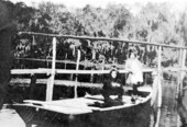Mrs. Lena B. Cole and Rosalee Cole in boat built by A.A. Cole..