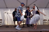 Kaleinani Ohumukini dances with an unidentified man while Henry Ohumukini and James Buchin plays at Florida Folklife Festival - White Springs, Florida.