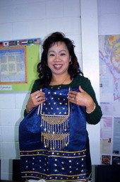 Kham Insouta (teacher) showing a piece of Lao dance costume at the Asian Neighborhood Center in St. Petersburg, Florida.