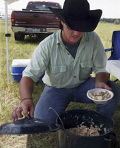 Cowboy getting some food during the Okee Ranch rodeo.
