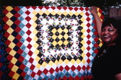 Patricia Inness with quilt made by her grandmother Rachel Sellers Cobb in Eatonville, Florida.