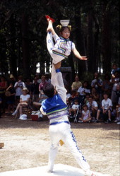 Dan Dan Zhao hold Xuefei Leng in the air at the Florida Folklife Festival - White Springs, Florida.