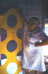 Annie Coleman holding a quilt : b Newberry, Florida