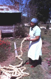 Lucreaty Clark holding a cornshuck rug she made- Lamont, Florida.