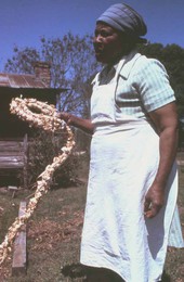 Lucreaty Clark holding a cornshuck rug she made- Lamont, Florida.