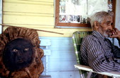 Sculptor Jesse J. Aaron sitting with one of his sculptures - Gainesville, Florida.