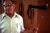 Claude Sheppard holding a whip he is braiding - Gainesville, Florida.