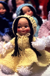 Close-up of doll with crocheted outfit