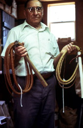 Whip maker, Claude Sheppard, holding a couple of his whips - Gainesville, Florida.