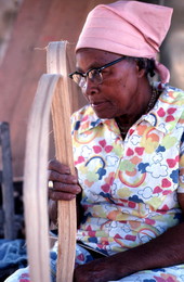 Lucreaty Clark rests from peeling strips of white oak for basket making