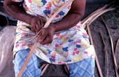 Lucreaty Clark preparing strip of white oak for basket making