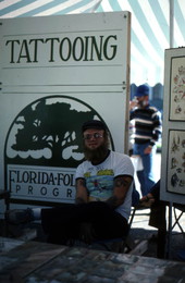 Tattoo artist Jon Fort at his tattoo stand - Pensacola, Florida.
