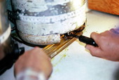 Putting melted rubber into a mold to make "Woody Worm" fishing lures- Inverness, Florida