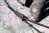 Close-up view of link between iron rods that ring the fire used to roast mullet - Monticello, Florida