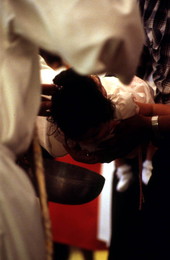 Child being baptised - Seville, Florida