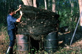 Old hoop net's resting on oil drums - Palatka, Florida.