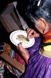 Lottie Shore sorting through beads for a Seminole sash - White Springs, Florida.