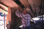 Bud Seymour takes measurements for new planks : Apalachicola, Florida.