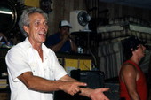 Furniture store owner pointing out bidders during auction led by auctioneer Randy Kerr - Jacksonville, Florida.
