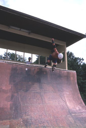 Skateboarder on a half pipe performing aerial moves - Jacksonville, Florida.