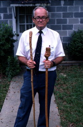 Bill Cooey with two walking sticks he carved - Milton, Florida