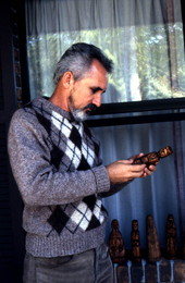 Domingo Carlo holding one of his wood carvings - Starke, Florida