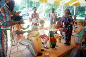 Konbo Guinyn band showing child how to play drums during the 1990 Florida Folk Festival - White Springs, Florida