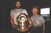 Nick Toth holding a Greek diving helmet while Antonios Lerios looks on - Tarpon Springs, Florida