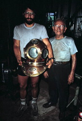 Nick Toth holding a Greek diving helmet while Antonios Lerios looks on - Tarpon Springs, Florida