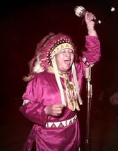 Creek Indian painter Fred Beaver singing and shaking a rattle at the Florida Folk Festival- White Springs, Florida.