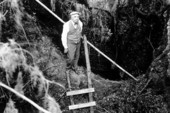 Walter Holmes looking down into entrance of Saber-Tooth Cave - Lecanto, Florida