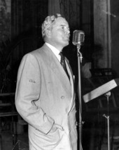 Fuller Warren speaking at the microphone in a very light rain