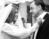 Governor Claude R. Kirk gets some help with his tie from daughter Kitty on her wedding day.