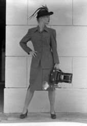 Model with a Speed Graphic camera.