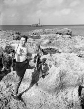 Sarasota photographer Joe Steinmetz at George Town in the Cayman Islands having his finger snapped by a turtle.
