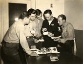 Naval Photography School instructor viewing photographic prints with students at NAS Pensacola.