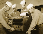 Naval Photography School instructor showing students how to use equipment at NAS Pensacola.