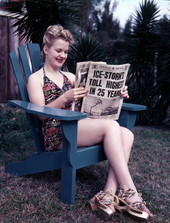 Unidentified woman in Sarasota reading the March 5, 1940 edition of the Daily News paper story about winter storms up north.