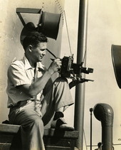 Photographer Joe Steinmetz taking a photograph on board a ship traveling to Guatemala.