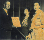 Koreshan Unity president Hedwig Michel, center, receiving an award certificate.