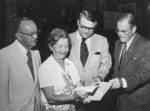 Men reading with Koreshan Unity president Hedwig Michel.