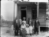 The Demps family outside their home