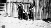 Florence Eloise Littleton standing with her two brothers in front of garage - Madison, Florida