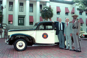 Highway Patrol members stand beside an antique patrol car - Tallahassee, Florida