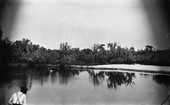 Lake, believed to be in Alachua County, with fisherman in foreground