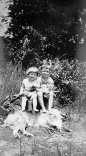 Boy and girl with cats and dog