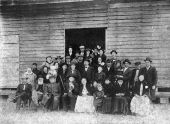 Large unidentified group posed next to a building - Havana, Florida.