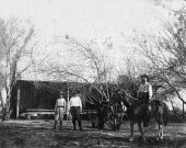 J.Q. Smith on a horse in front of his home