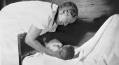 Midwife holding just delivered baby